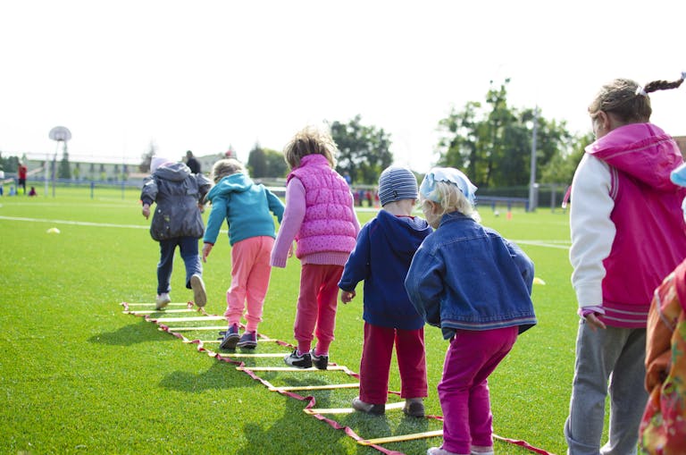 Children's Team Building on Green Grassland